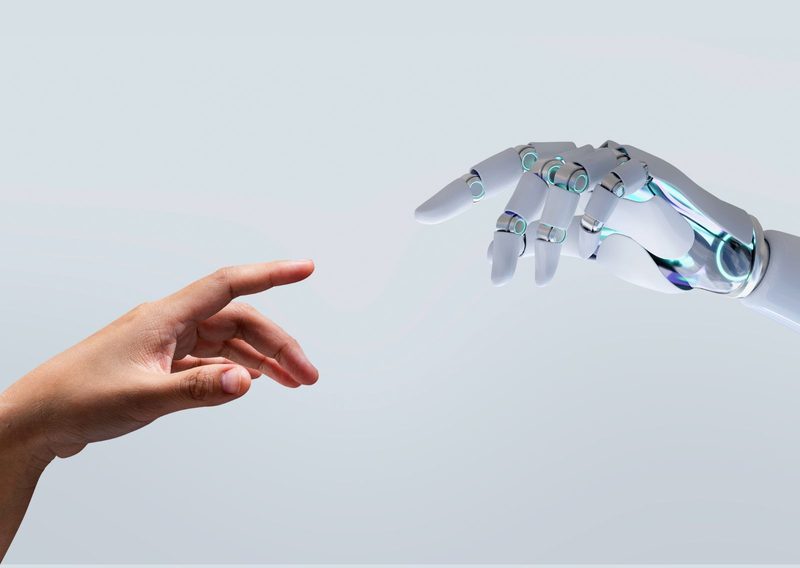 A human hand and a robotic hand reaching towards each other